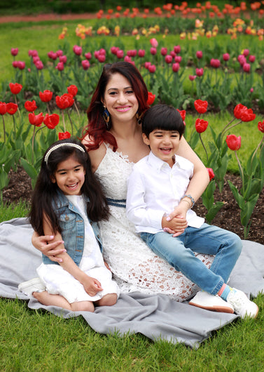 portrait of mother with daugther and son sitting with tulips